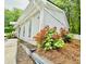 Side view of a single-story house with well-maintained landscaping and mature trees at 4437 Janice Dr, Snellville, GA 30039