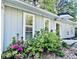 Quaint single-story home with gray siding and white trim, surrounded by lush greenery at 4437 Janice Dr, Snellville, GA 30039