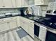 Modern kitchen with black countertops and stainless steel appliances ready for cooking at 4437 Janice Dr, Snellville, GA 30039