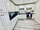 Well-lit kitchen with white cabinets and stainless steel appliances for a modern look at 4437 Janice Dr, Snellville, GA 30039