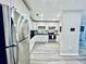 Open kitchen with stainless steel fridge, white cabinets, and modern appliances at 4437 Janice Dr, Snellville, GA 30039