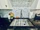 Updated kitchen featuring stainless steel sink, stone backsplash, and modern faucet at 4437 Janice Dr, Snellville, GA 30039