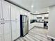 Spacious kitchen featuring stainless steel appliances, white cabinets, and ample storage at 4437 Janice Dr, Snellville, GA 30039
