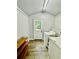 Bright laundry room with wood-look floors and a convenient exterior door at 4437 Janice Dr, Snellville, GA 30039