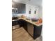 Modern kitchen featuring stainless steel appliances, granite countertops, and dark cabinetry at , Union City, GA 30349