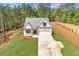 An aerial view of a modern home with an attached garage, long drive, and surrounded by trees at 1408 Campbell Rd, Covington, GA 30014