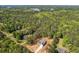 Aerial view of the property surrounded by lush greenery, near a tranquil lake at 1408 Campbell Rd, Covington, GA 30014