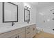 Bright bathroom featuring double sinks with shaker cabinets, tile flooring, and a tiled shower with glass door at 1408 Campbell Rd, Covington, GA 30014