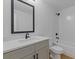 Bathroom with a modern vanity, a framed mirror, and a shower-tub combo with white subway tile at 1408 Campbell Rd, Covington, GA 30014