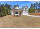 Charming new construction exterior with white siding, wood accents, and attached garage at 1408 Campbell Rd, Covington, GA 30014