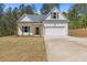 Charming one-story home featuring a two-car garage, a welcoming front porch, and a well-maintained lawn at 1408 Campbell Rd, Covington, GA 30014