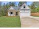 Charming single-story home featuring a welcoming front porch, attached garage, and freshly manicured lawn at 1408 Campbell Rd, Covington, GA 30014