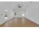 Bright, open living room with large windows, a ceiling fan, and a neutral color palette at 1408 Campbell Rd, Covington, GA 30014