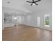 Spacious living room showcasing wood floors, large windows, recessed lighting, and seamless flow to kitchen at 1408 Campbell Rd, Covington, GA 30014