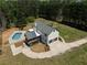 Aerial view of a beautiful home with a long drive, in-ground pool, and wooded surroundings at 3984 Earney Rd, Woodstock, GA 30188