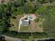 Overhead shot of home with pool and circular driveway surrounded by verdant foliage at 3984 Earney Rd, Woodstock, GA 30188