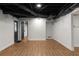 Finished basement with exposed ceiling and wood floors at 3984 Earney Rd, Woodstock, GA 30188
