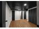 Finished basement with black ceiling tiles, multiple doors, and vinyl plank flooring at 3984 Earney Rd, Woodstock, GA 30188