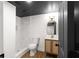 This stylish bathroom features a tiled shower and a vanity with a gold faucet and mirror at 3984 Earney Rd, Woodstock, GA 30188