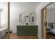 Bathroom features a double vanity with marble countertop and arched mirrors at 3984 Earney Rd, Woodstock, GA 30188
