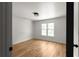 Bedroom with hardwood floors, neutral walls, natural light, and modern light fixture at 3984 Earney Rd, Woodstock, GA 30188