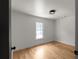 This bedroom offers light hardwood floors, neutral paint and a bright window at 3984 Earney Rd, Woodstock, GA 30188