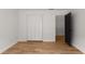 Bright bedroom features hardwood floors, white walls, and a closet for ample storage at 3984 Earney Rd, Woodstock, GA 30188