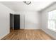 Bright bedroom features hardwood floors, a window, and modern lighting fixture at 3984 Earney Rd, Woodstock, GA 30188