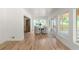 Bright dining room with white walls, hardwood floors, and an outdoor deck visible through the windows at 3984 Earney Rd, Woodstock, GA 30188