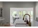 Dining room with white chairs, a round table, and an open doorway to an outdoor deck at 3984 Earney Rd, Woodstock, GA 30188