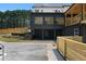 Exterior of home with large windows, steps, and new fence at 3984 Earney Rd, Woodstock, GA 30188