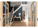 Elegant foyer with hardwood floors, staircase with iron spindles and decorative paneled wall at 3984 Earney Rd, Woodstock, GA 30188