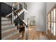 Open foyer with hardwood floors, an elegant staircase and a view to the living room at 3984 Earney Rd, Woodstock, GA 30188
