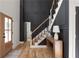 Bright foyer with hardwood floors, an elegant staircase, and modern black paneled accent wall at 3984 Earney Rd, Woodstock, GA 30188