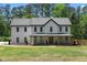 Charming two-story home with a welcoming front porch and manicured lawn at 3984 Earney Rd, Woodstock, GA 30188