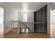 Bright hallway features hardwood floors, modern light fixture, and a view of the home's exterior through a window at 3984 Earney Rd, Woodstock, GA 30188