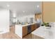 Open concept kitchen featuring an island, stainless steel appliances, light wood cabinets, and hardwood floors at 3984 Earney Rd, Woodstock, GA 30188