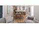 Open-concept living room with kitchen view featuring wood floors and neutral décor at 3984 Earney Rd, Woodstock, GA 30188