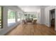 Open living space with hardwood floors, neutral furniture, and large windows offering views of the pool and backyard at 3984 Earney Rd, Woodstock, GA 30188
