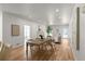Open-concept living room and dining area with fireplace and hardwood floors, bathed in natural light at 3984 Earney Rd, Woodstock, GA 30188