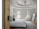 Main bedroom with tray ceilings, light gray rug, and a barn door to the closet at 3984 Earney Rd, Woodstock, GA 30188