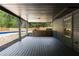Open porch area with wooden deck overlooks pool and scenic backyard view at 3984 Earney Rd, Woodstock, GA 30188