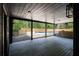 Enjoy open porch with wood floors overlooking pool and scenic backyard view at 3984 Earney Rd, Woodstock, GA 30188