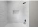 Updated tiled shower features modern black shower head and fixtures at 3984 Earney Rd, Woodstock, GA 30188
