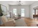 Cozy sitting room with hardwood floors, bright natural light and a view to the front door at 3984 Earney Rd, Woodstock, GA 30188