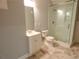 Bathroom with a modern glass shower, vanity, and marble-tiled floor at 4101 Brookview Se Dr, Atlanta, GA 30339