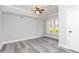 Bedroom featuring grey vinyl floors, a ceiling fan, a window, and white trim at 4101 Brookview Se Dr, Atlanta, GA 30339