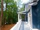 The spacious covered porch features white columns, ceiling fans and provides a view of the wooded yard at 4101 Brookview Se Dr, Atlanta, GA 30339