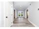 Hallway with grey vinyl floors, neutral-colored walls, and view of a pair of white glass doors at 4101 Brookview Se Dr, Atlanta, GA 30339