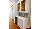 Kitchen nook with glass cabinets, wine fridge, white countertops, and tile backsplash at 4101 Brookview Se Dr, Atlanta, GA 30339